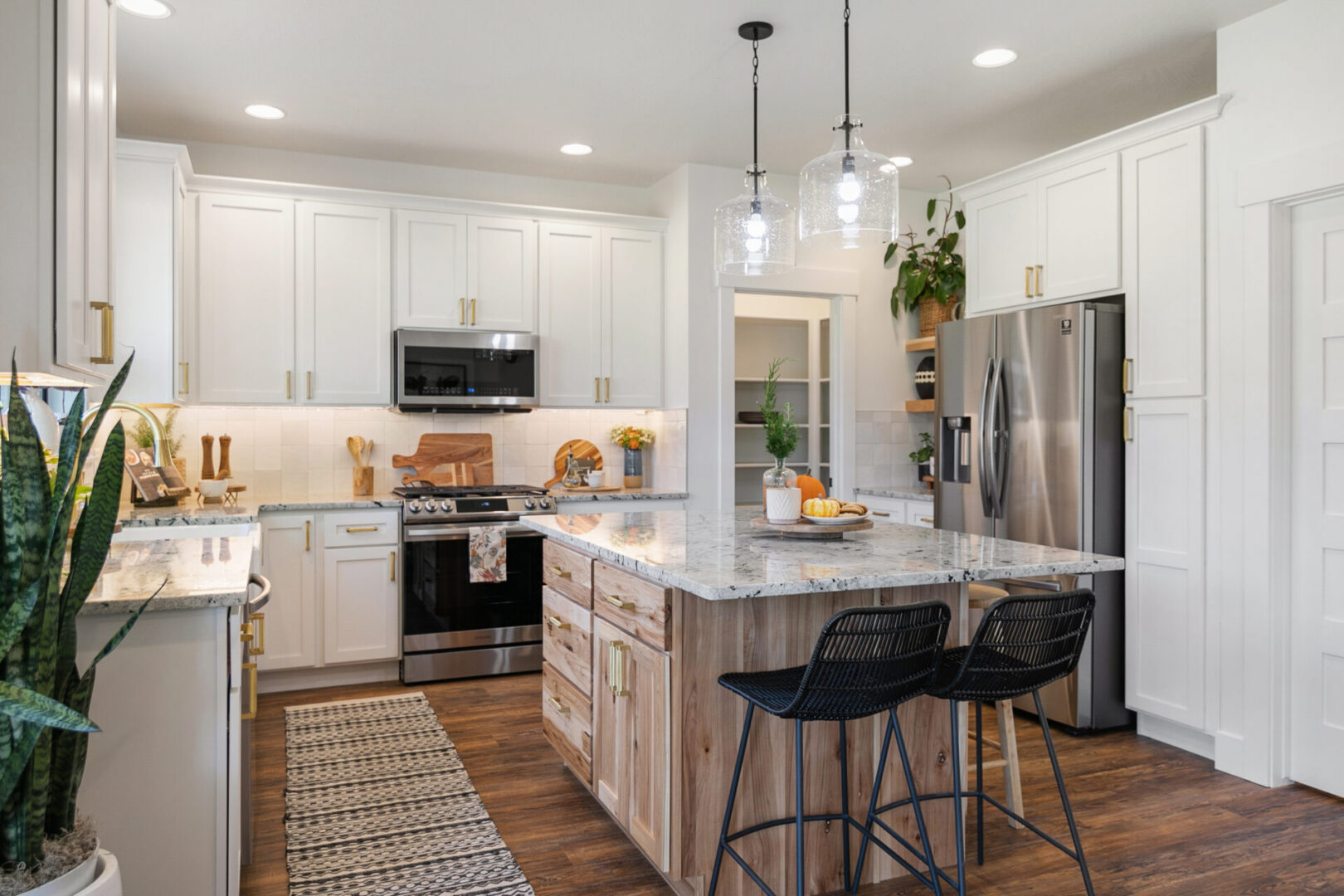Modern kitchen with island and bar stools.